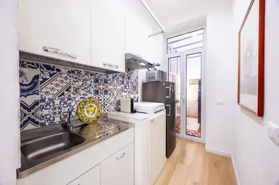 a small kitchen with a sink and a microwave at La Casa di Freda in Palermo