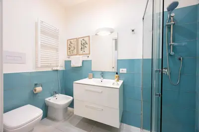 a bathroom with a toilet and a sink and a shower at La Casa di Freda in Palermo