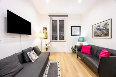 a living room with a couch and a flat screen tv at La Casa di Freda in Palermo
