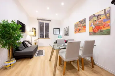 a living room with a table and chairs and a couch at La Casa di Freda in Palermo