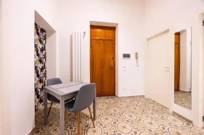 a room with a table and chairs and a door at Casa D'Ondes in Palermo