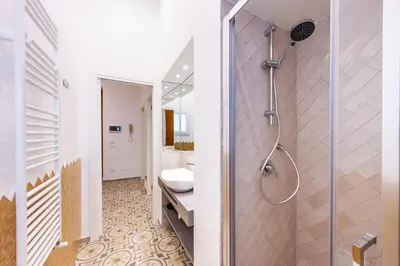 a bathroom with a shower and a toilet in it at Casa D'Ondes in Palermo