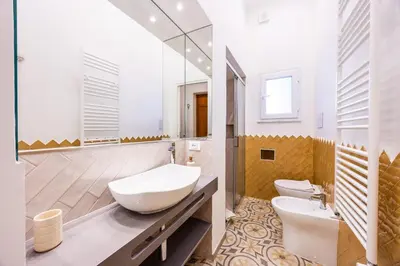 a bathroom with two toilets and a sink at Casa D'Ondes in Palermo