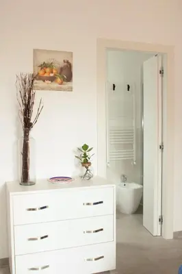 a bathroom with a white dresser and a sink at Mondello bed & beach in Palermo