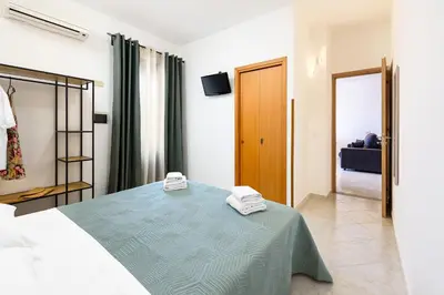 a bedroom with a bed with two towels on it at Beach View Apartment in San Vito lo Capo