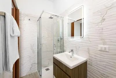 a bathroom with a sink and a shower at Beach View Apartment in San Vito lo Capo