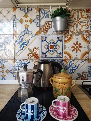 a kitchen counter with two cups and a tea kettle at Capo Petit Apartment in Palermo
