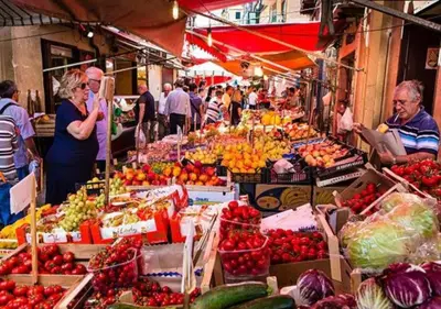 a market with many fruits and vegetables on display at Capo Petit Apartment in Palermo