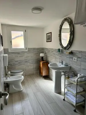 a bathroom with a sink and a toilet and a mirror at Leon in Palermo