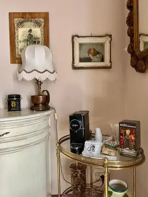 a room with a table with a lamp on it at Leon in Palermo