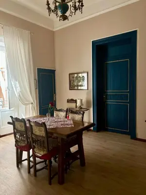 a dining room with a wooden table and chairs at Leon in Palermo