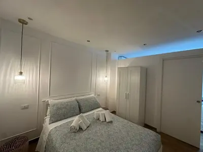 a bedroom with a bed with two towels on it at Glamour home in Palermo