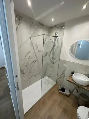 a bathroom with a shower and a toilet and a sink at Glamour home in Palermo