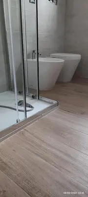 a bathroom with a sink and a toilet in a room at Casa Viola - Central Apartment City & Sea in Alcamo