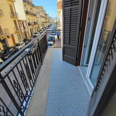 an open door to a balcony with a street at Casa Viola - Central Apartment City & Sea in Alcamo