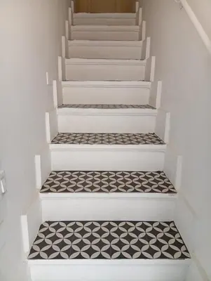 a staircase with black and white tiles on the floor at Eli's Home in Terrasini