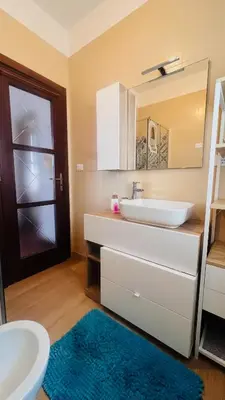 a bathroom with a sink and a toilet and a mirror at Kasa Mondello in Mondello