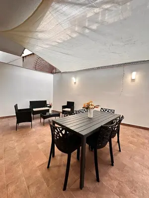 a table and chairs in a room with a ceiling at Kasa Mondello in Mondello