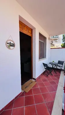 a balcony of a house with a red tile floor at Kasa Mondello in Mondello