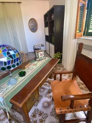 a room with a wooden table and a chair at Villa Melina in Carini