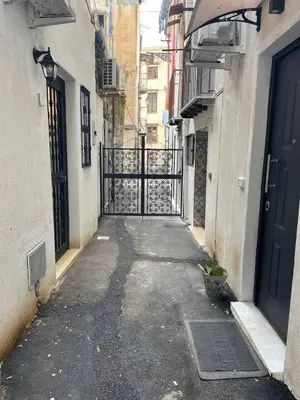 an alley with an open gate in a city at Nel Vicoletto House in Palermo