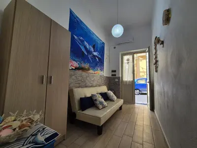 a living room with a couch and a bed at Ad 1 passo dal mare Mondello in Palermo