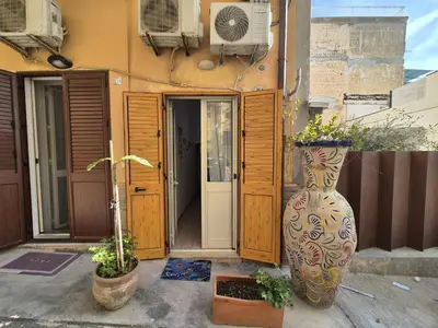 two large vases sitting in front of a building at Ad 1 passo dal mare Mondello in Palermo