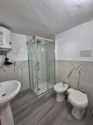 a bathroom with a glass shower and a toilet at Ad 1 passo dal mare Mondello in Palermo