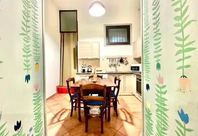 a kitchen with a table and chairs in a room at Casetta Nenè - Palermo Centrocittà - Intero Appartamento in Palermo