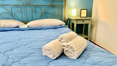 a bedroom with a bed with towels on it at Casetta Nenè - Palermo Centrocittà - Intero Appartamento in Palermo