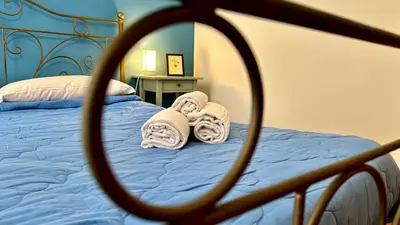 a bedroom with a bed with towels on it at Casetta Nenè - Palermo Centrocittà - Intero Appartamento in Palermo