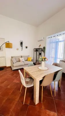 a living room with a table and chairs and a couch at Kasa Magnisi in Palermo