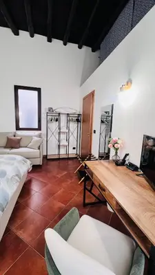 a living room with a wooden table and a couch at Kasa Magnisi in Palermo