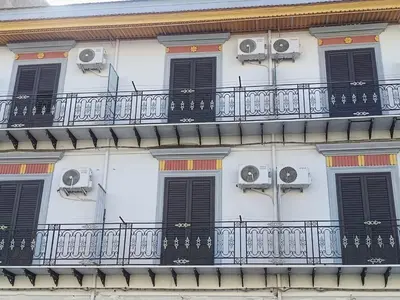 a building with black windows and a balcony at Casa Mille in Palermo