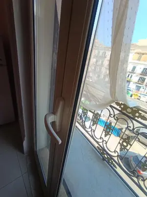 an open window with a view of a city at Casa Mille in Palermo