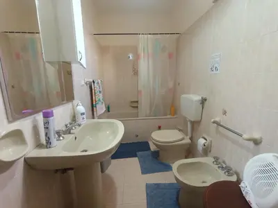 a bathroom with two sinks and a toilet and a shower at Casa Mille in Palermo