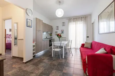 a living room with a red couch and a table at GuestHost - Palermo Flat with Terrace near Villa Malfitano in Palermo