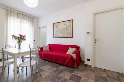 a living room with a red couch and a table at GuestHost - Palermo Flat with Terrace near Villa Malfitano in Palermo