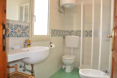 a bathroom with a sink and a toilet at B&B Talìa in Scopello