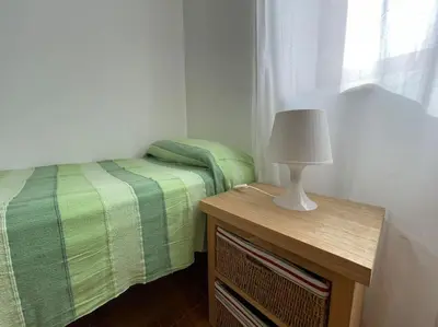 a bedroom with a bed and a table with a lamp at I Cinque Archi Apartment in Alcamo