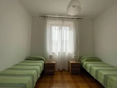 two twin beds in a room with a window at I Cinque Archi Apartment in Alcamo