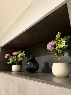 three vases sitting on a shelf with flowers in them at Casa marchese ,vacanze in centro -by Rentalbeb italy- in Palermo