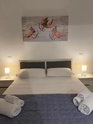 a bedroom with a bed with towels on it at Casa marchese ,vacanze in centro -by Rentalbeb italy- in Palermo