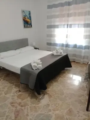 a bedroom with a bed with towels on it at Framami Red Ballerino in Palermo
