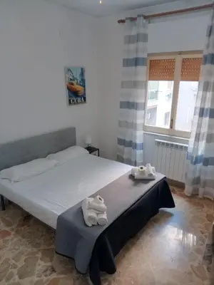 a bedroom with a bed with towels on a table at Framami Red Ballerino in Palermo