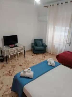 a room with a bed and a chair and a desk at Framami Red Ballerino in Palermo