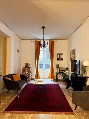 a living room with a couch and a table at Luxury Apartment Palazzo Vannucci in Palermo