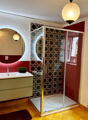 a bathroom with a shower with a sink and a mirror at Luxury Apartment Palazzo Vannucci in Palermo