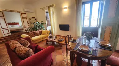 a living room with a table and chairs at Note di Palermo Loft in Palermo
