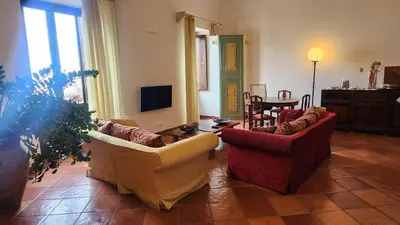 a living room with two chairs and a table at Note di Palermo Loft in Palermo